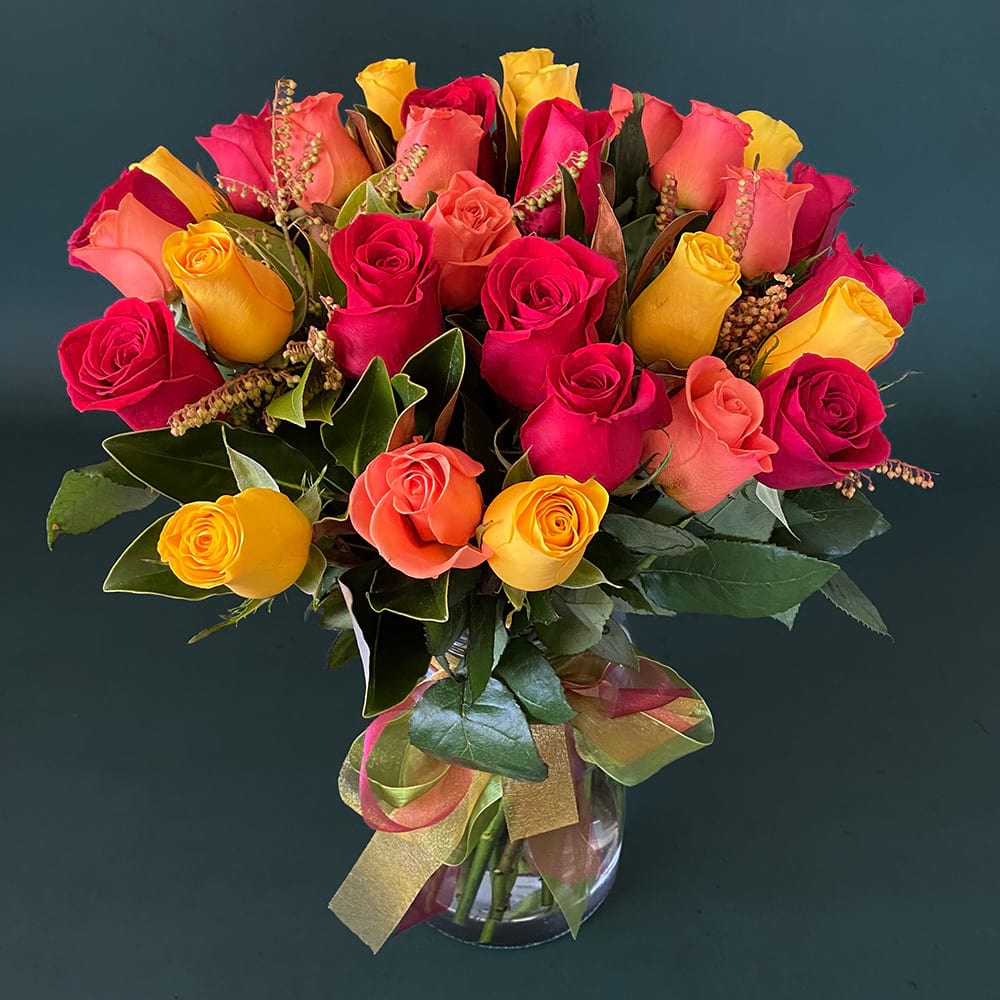 La Vie En Rose premium rose arrangement featuring seasonal foliage presented in a premium vase