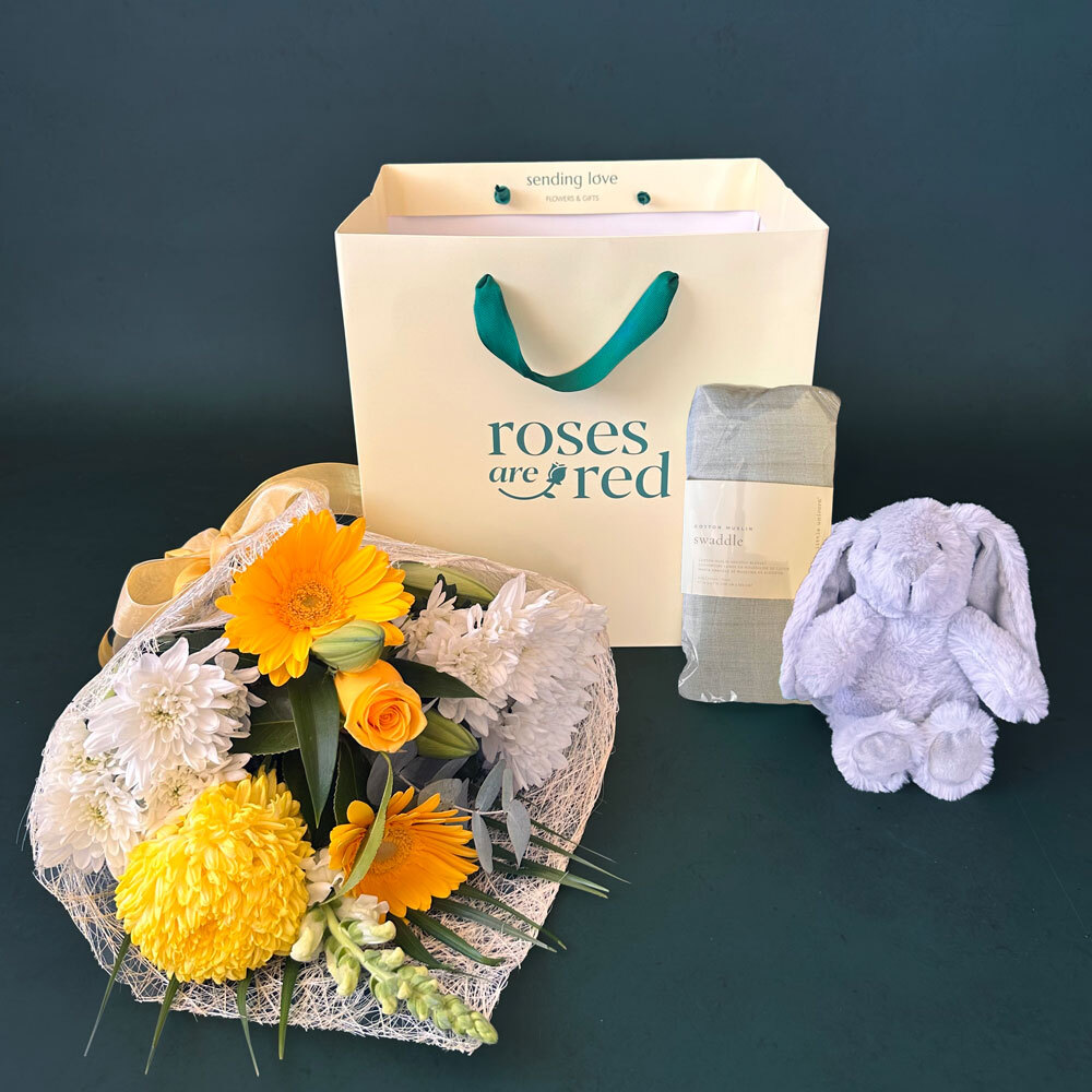 Boy Baby Bunny Gift featuring yellow and white flowers, a Lily & George Littlefoot plush toy and cotton muslin wrap