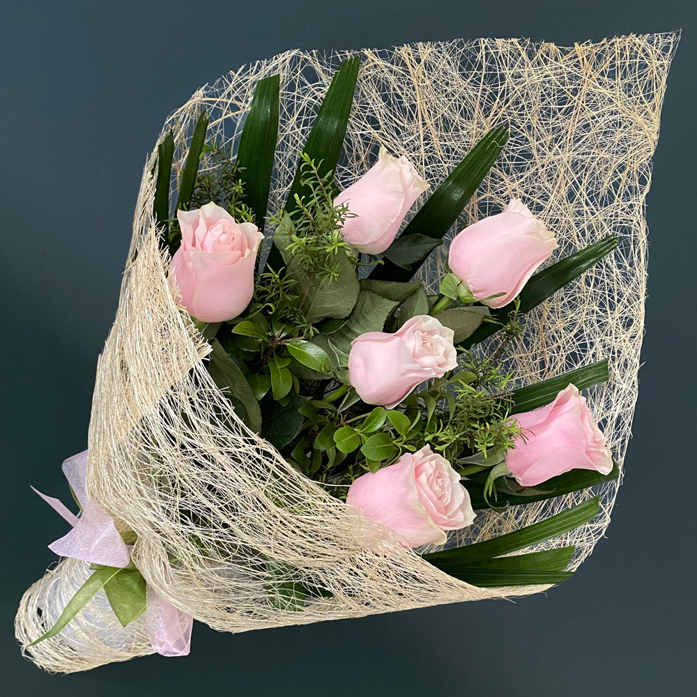 Sweet Pink Rose Bouquet featuring premium Colombian pink roses with seasonal foliage beautifully wrapped for delivery