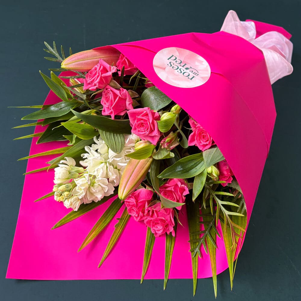 Hot Pink Posy featuring pink spray roses, fragrant Oriental lily and seasonal hot pink flowers with fresh foliage